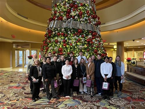Group photo of culinary arts students in front of tree at Turning Stone